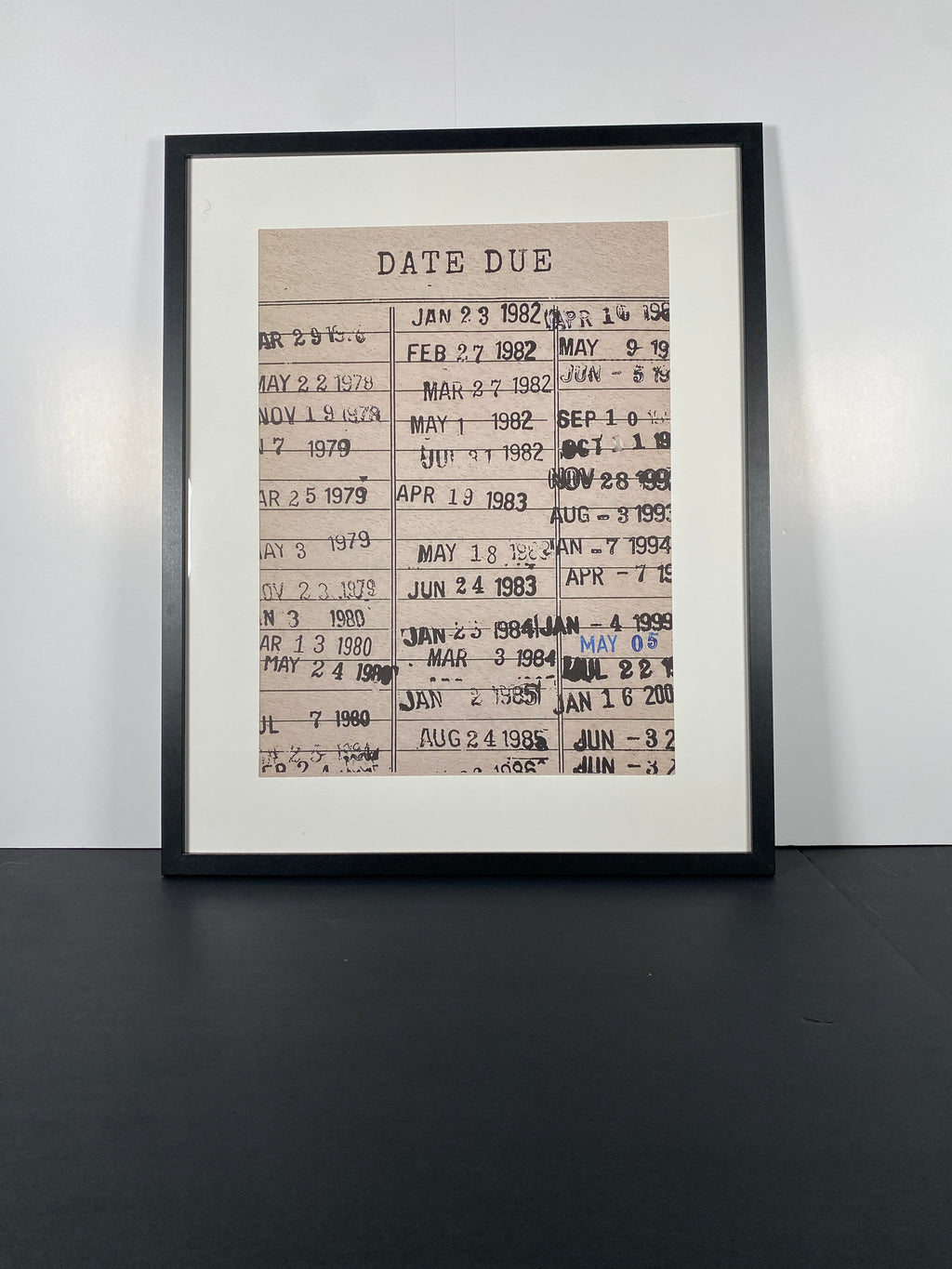 "Due Date" Canvas Art Piece in Modern Black Frame and White Matte.