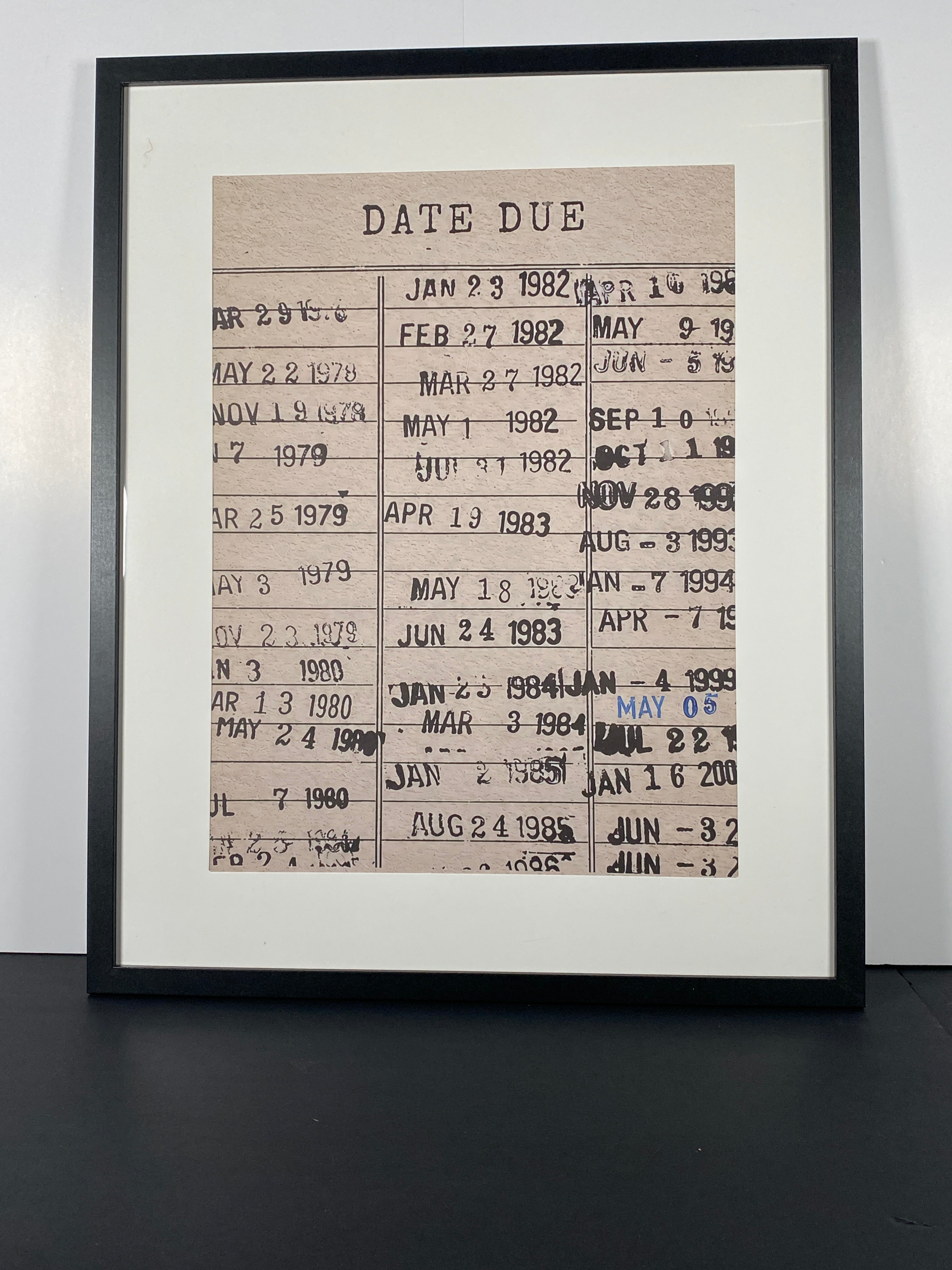 "Due Date" Canvas Art Piece in Modern Black Frame and White Matte.