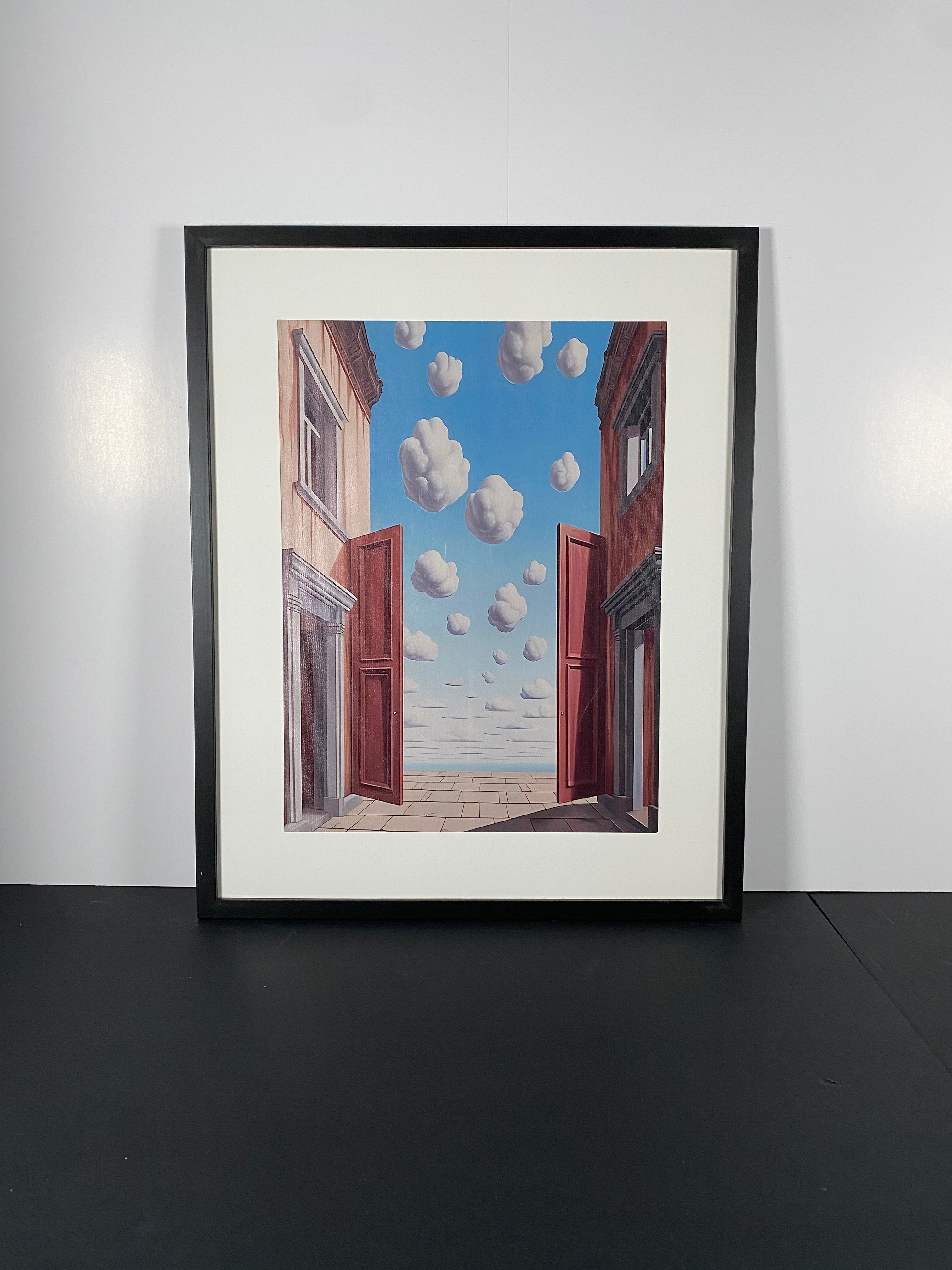 "L'embellie" (The Improvement) Canvas Art Print by Rene Magritte in Modern Black Frame.