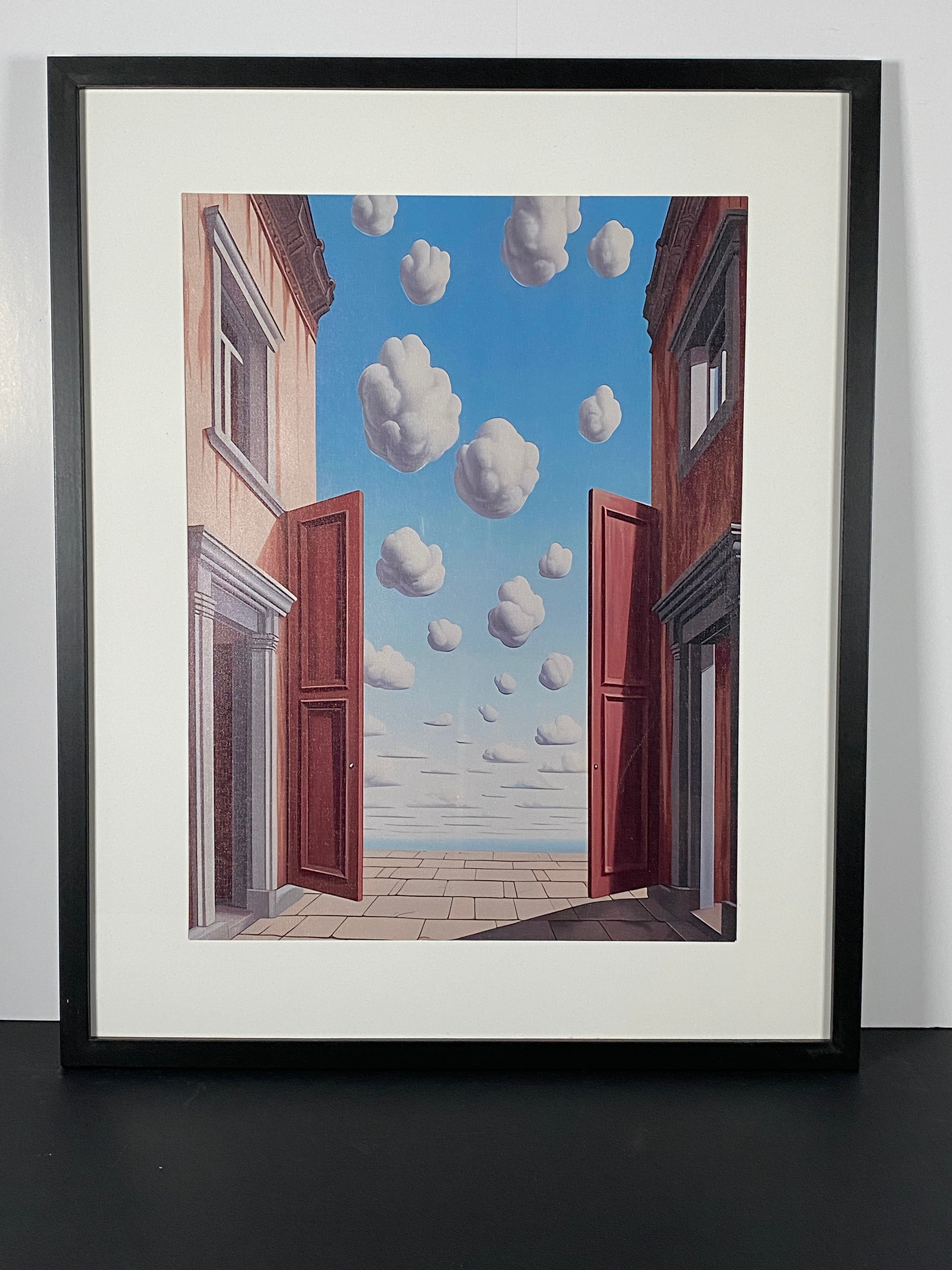 "L'embellie" (The Improvement) Canvas Art Print by Rene Magritte in Modern Black Frame.